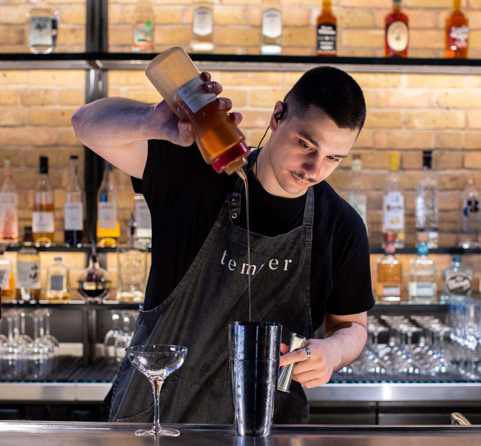 Barman pouring a cocktail